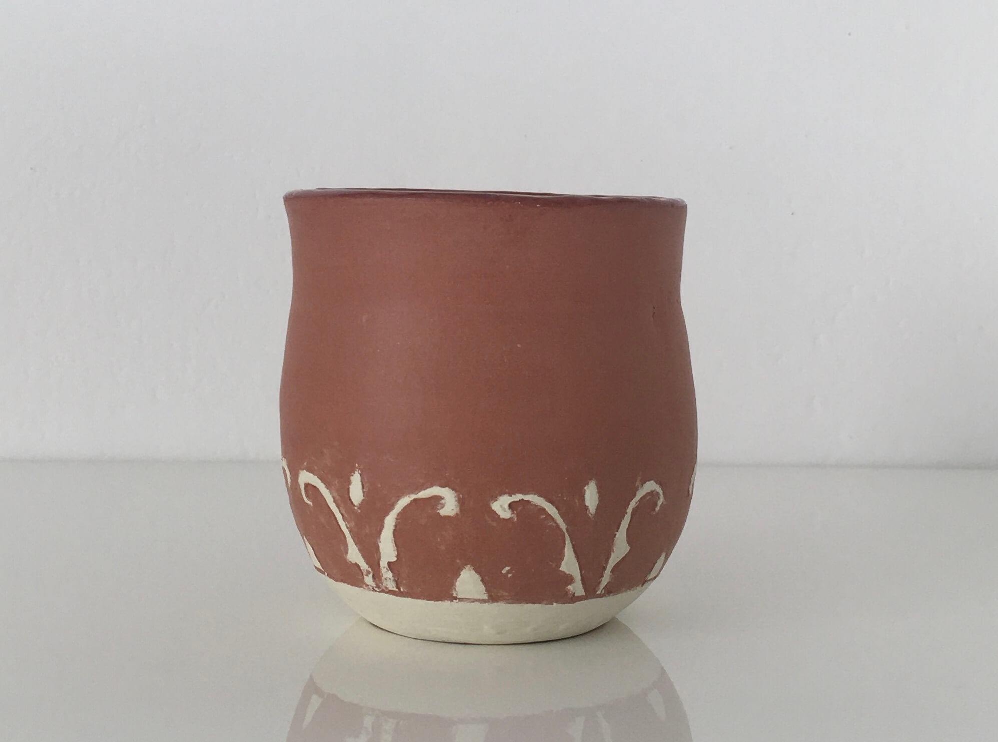 Tazza in terracotta con decoro bianco